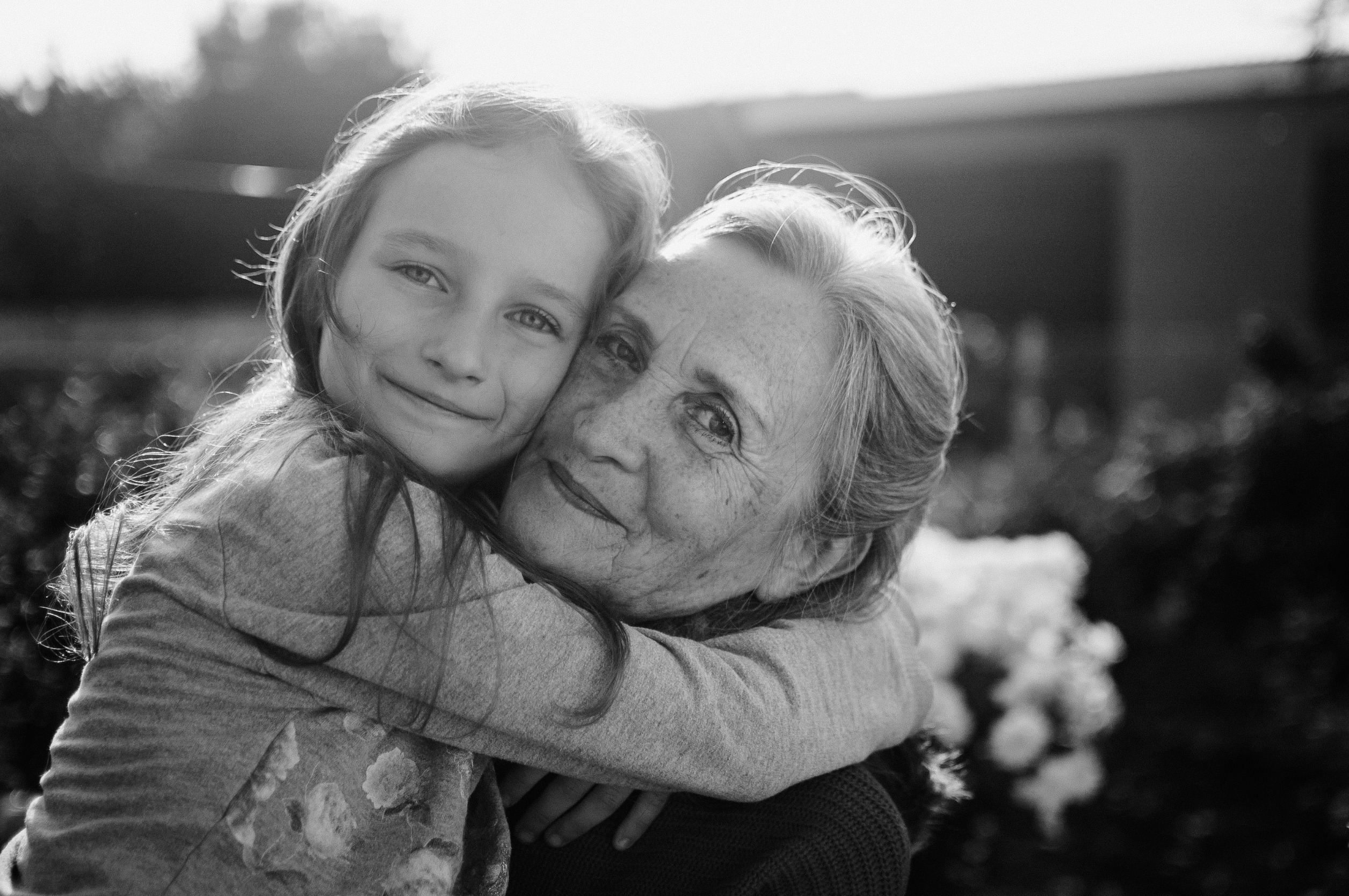 grandmother hugging her granddaughter